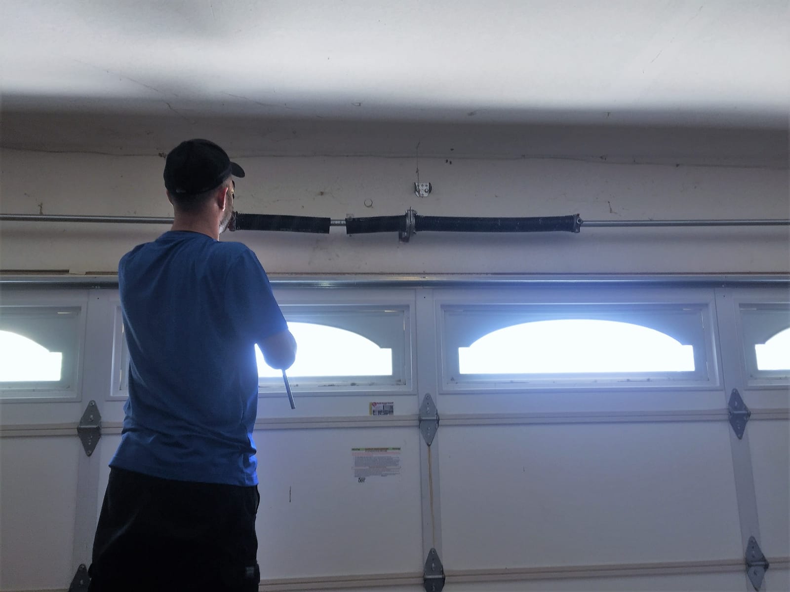 AER technician repairing a garage door in Sherman Oaks