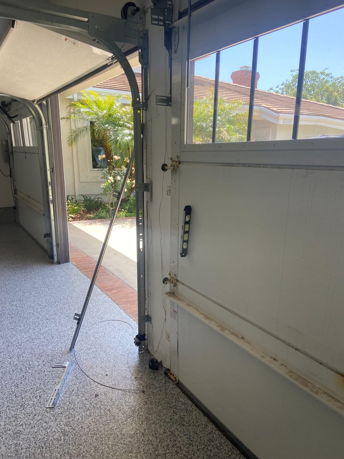 Damaged garage door needing emergency repair
