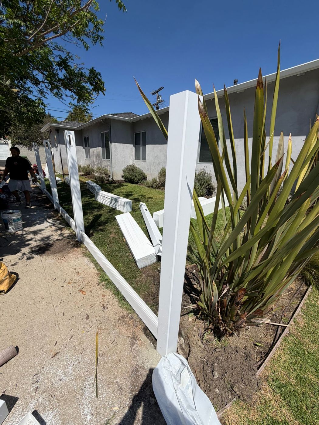 Vinyl fence posts and rails being installed